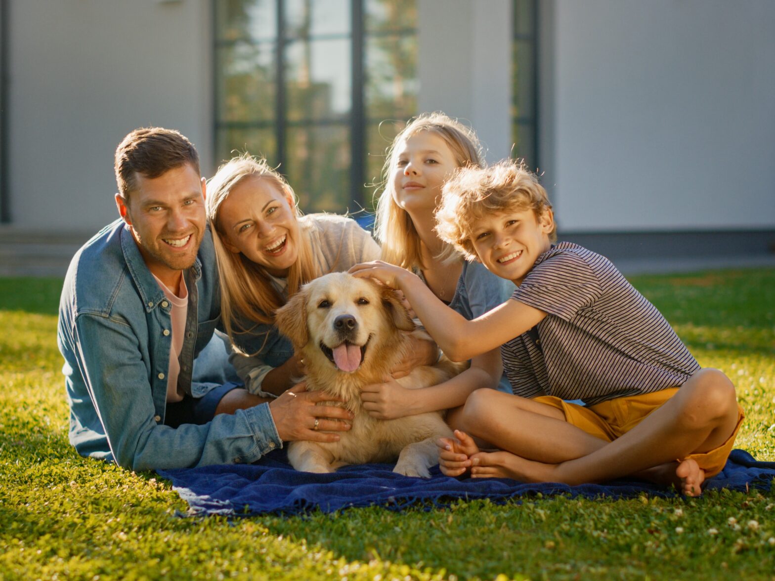 Photo of a family with their dog in the backyard